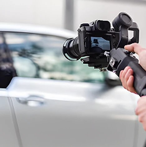 Cinema camera rig filming a car on set